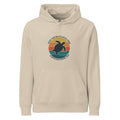 A front-facing flat lay of the beige organic hoodie. The image highlights the center kangaroo pocket, adjustable drawstrings, and the colorful retro-style turtle graphic centered on the chest.