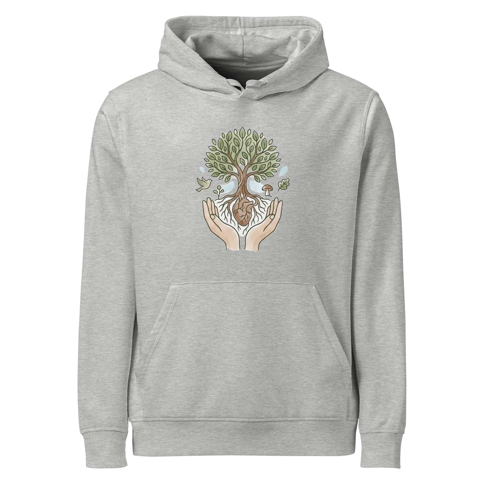 A high-resolution front view of a grey organic hoodie. The central graphic features two open hands cradling a leafy tree. The tree's roots are intertwined with a brown heart, and small environmental elements like a bird, a mushroom, and a falling leaf surround the branches.
