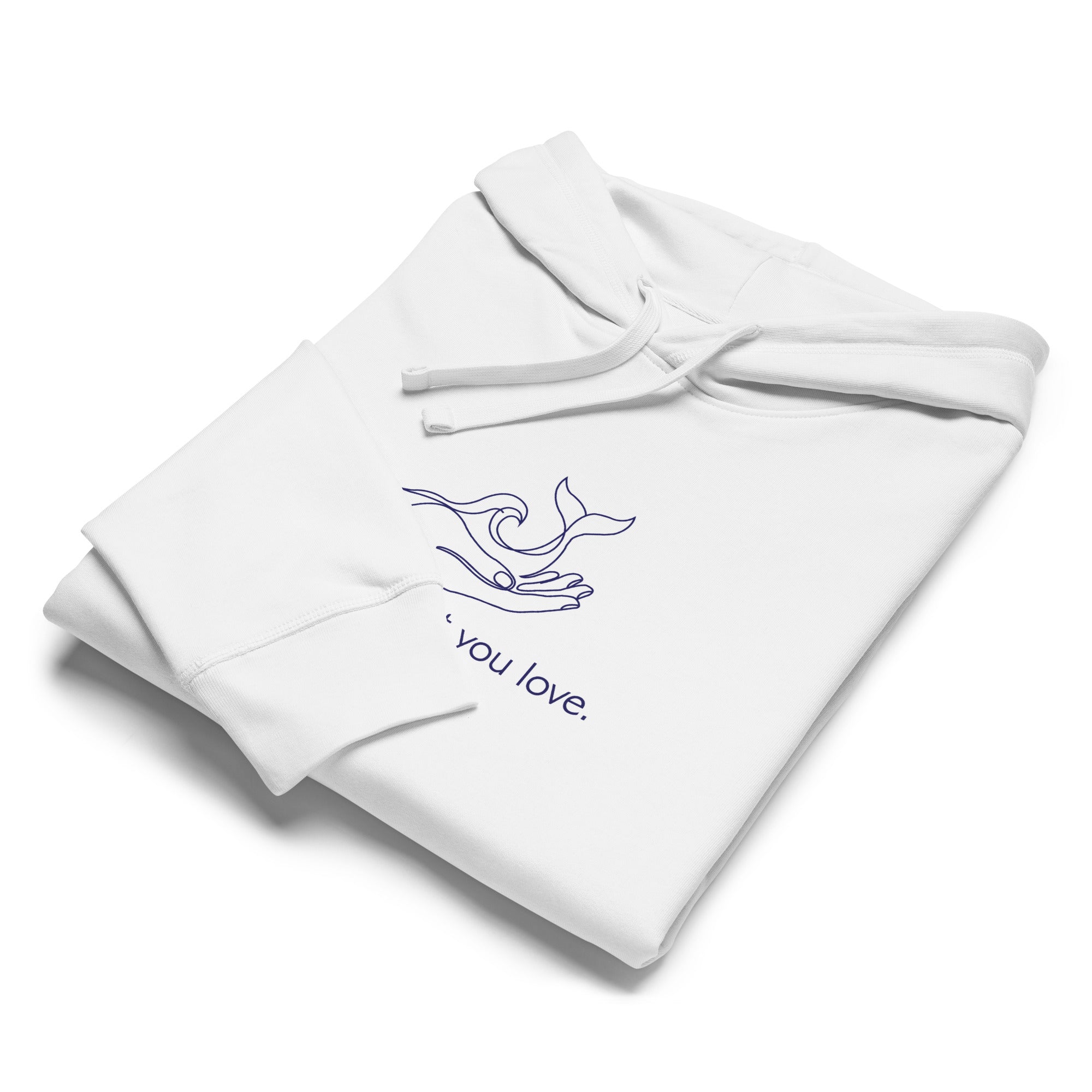 A white hoodie neatly folded on a flat white surface, showcasing the blue minimalist "protect what you love." whale and wave graphic.