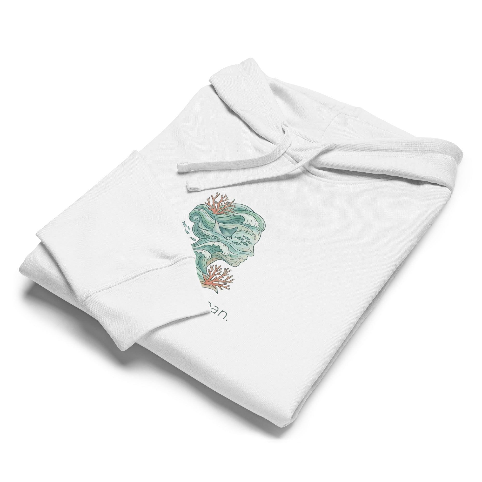 A neatly folded white hoodie shown from an elevated angle on a white surface. The fold highlights the sleeve cuff and a portion of the ocean-themed graphic, showcasing the soft texture of the organic material.