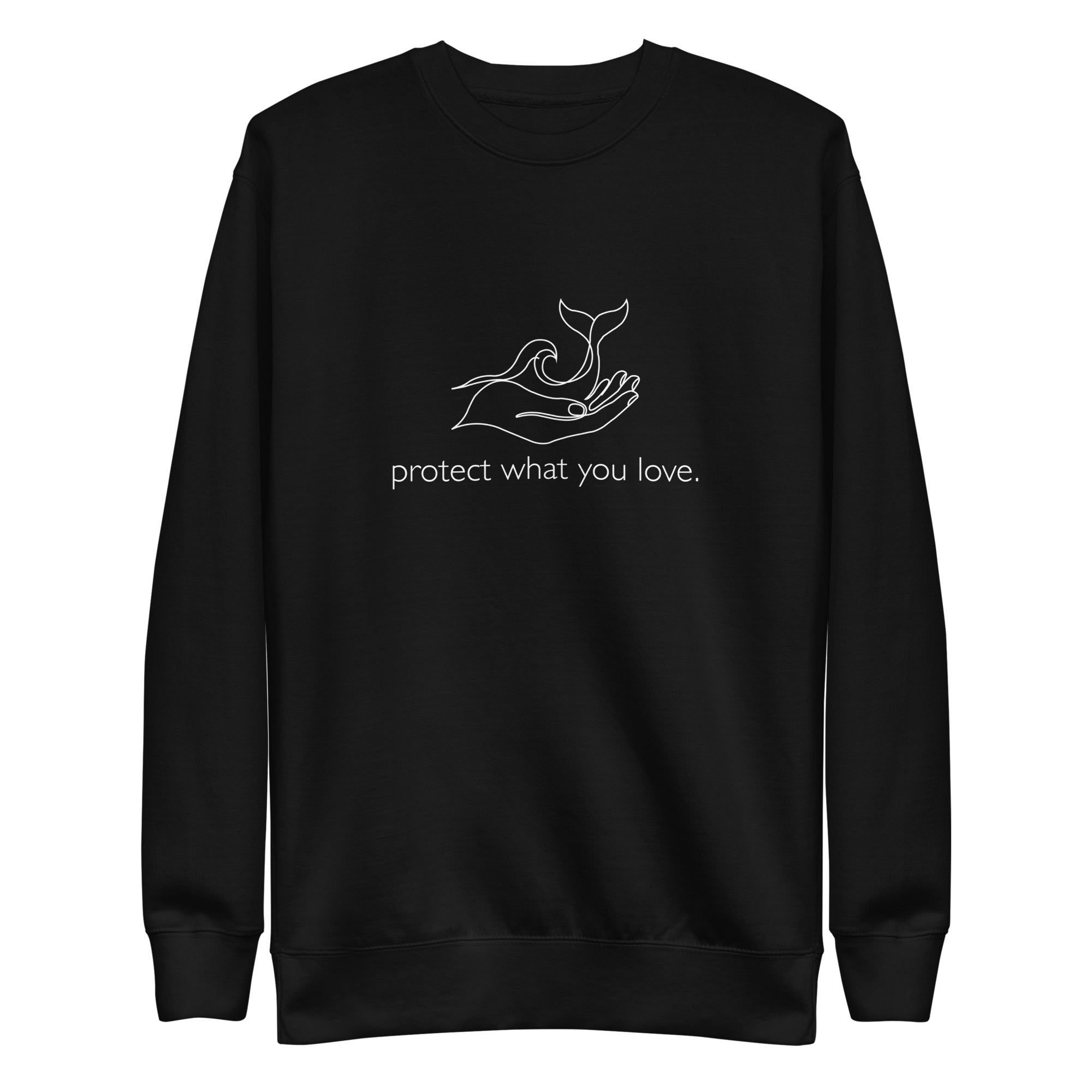 A high-resolution front view of a black organic crewneck sweatshirt. Centered on the chest is a minimalist white line art graphic of a hand cradling a whale's tail and an ocean wave, with the lowercase phrase "protect what you love." printed beneath it.