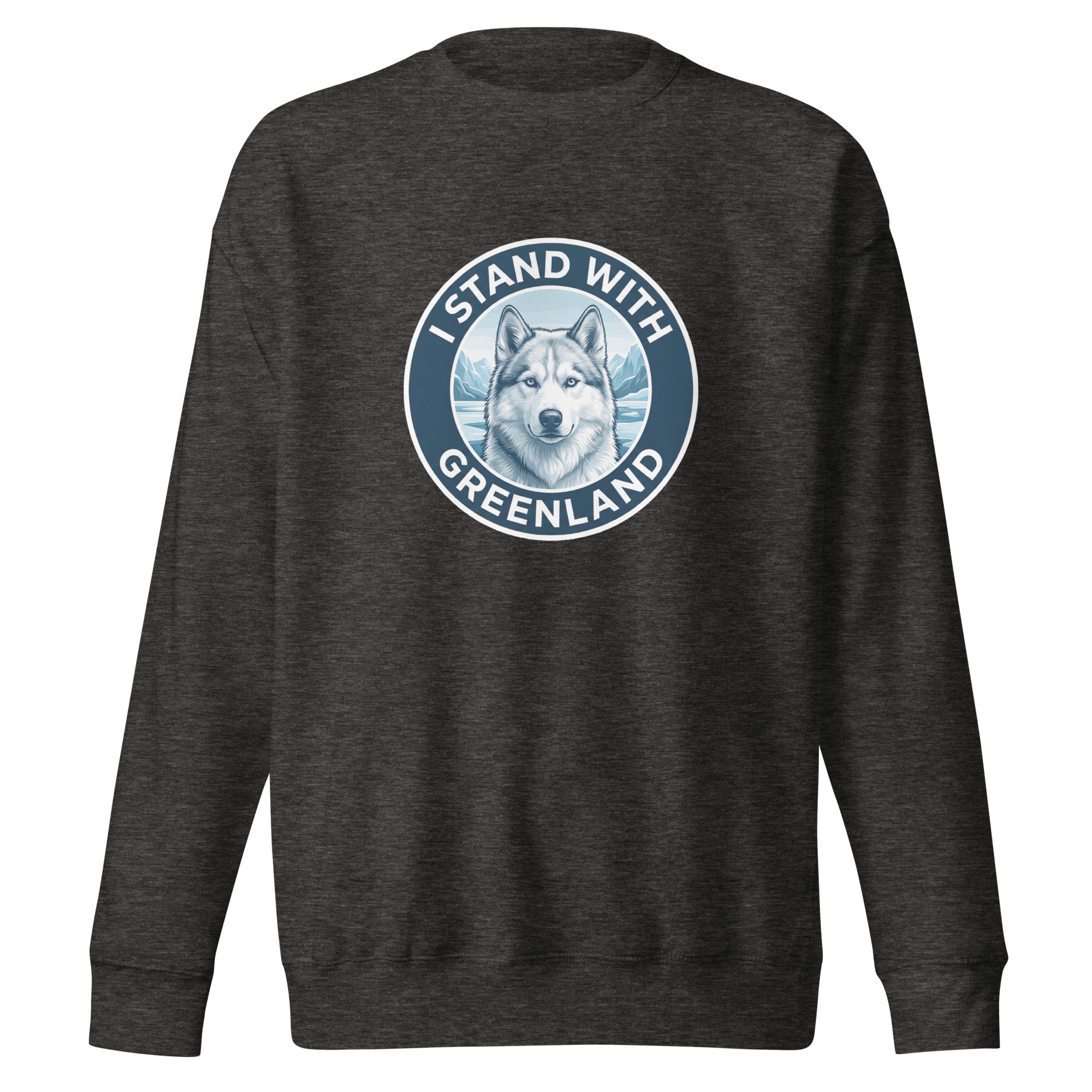 A white long-sleeved crew-neck sweatshirt laid flat against a grey background, featuring a centered circular navy blue emblem with a husky's face and the words "I STAND WITH GREENLAND."