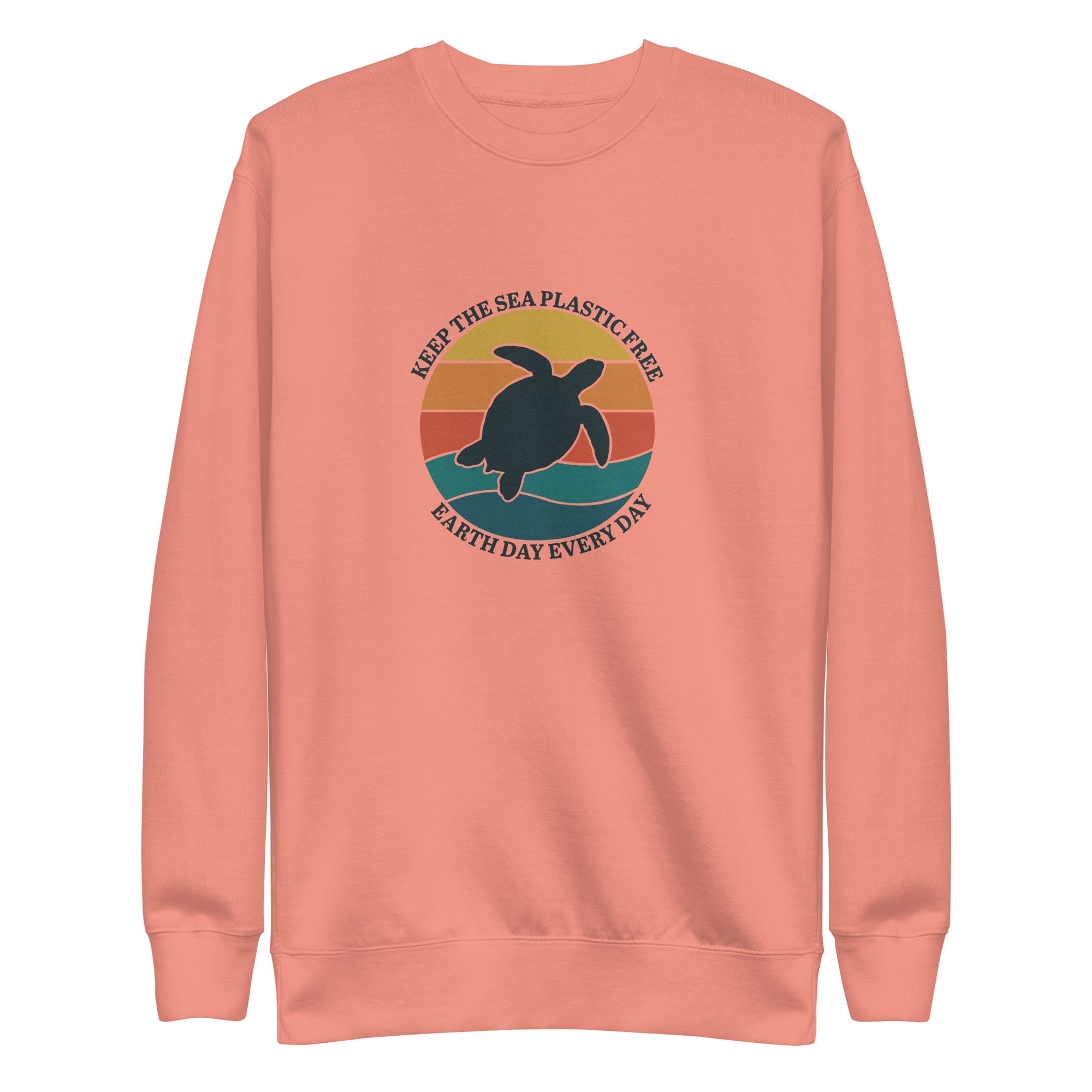 A high-resolution front view of a rose-colored organic crewneck sweatshirt. The central design is a large circular graphic with a retro sunset in shades of orange and teal. A dark silhouette of a sea turtle is centered over waves, surrounded by the text "KEEP THE SEA PLASTIC FREE" and "EARTH DAY EVERY DAY".
