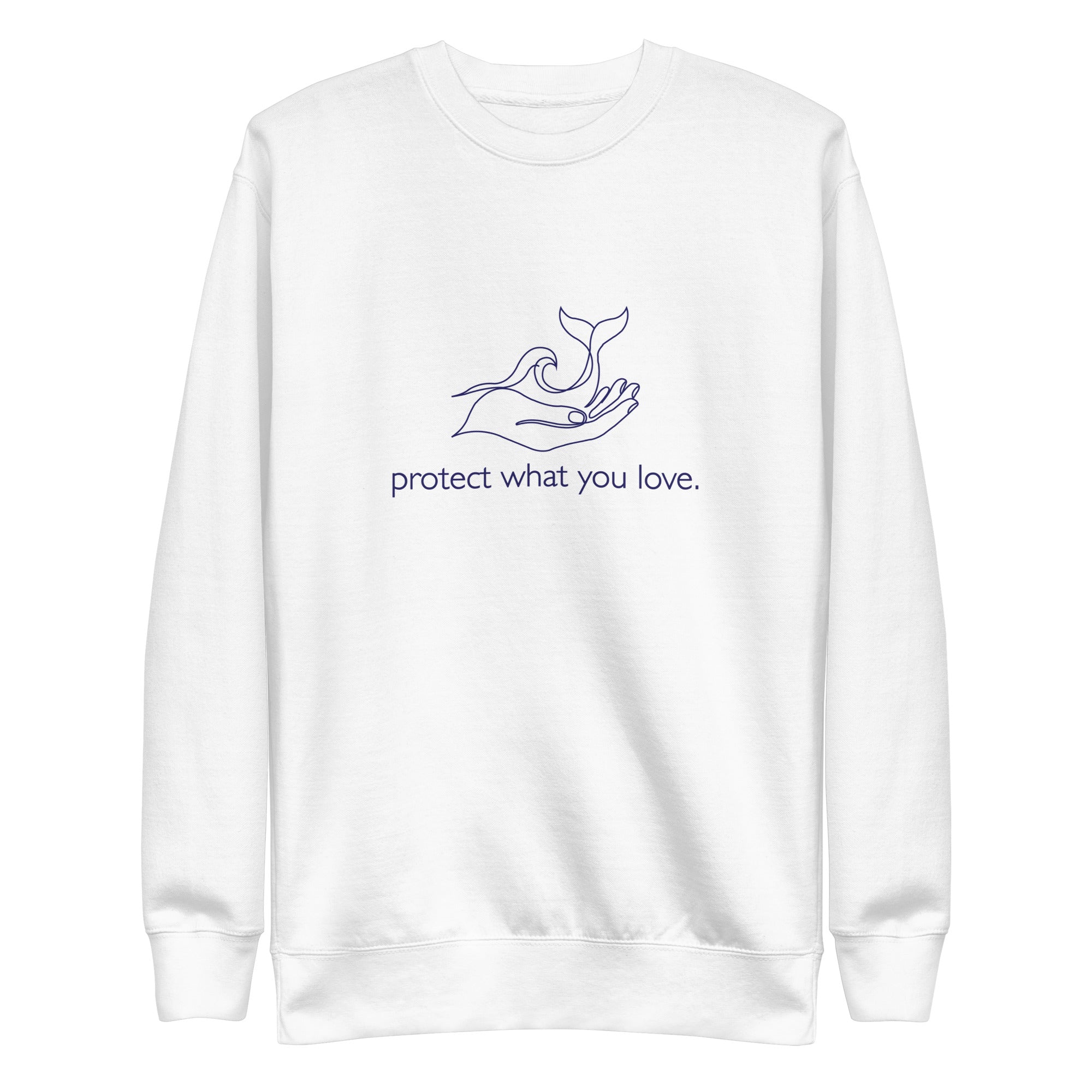 A high-resolution front view of a white premium crewneck sweatshirt. The central design is a minimalist navy blue line art illustration showing a hand gently cradling a whale's tail and an ocean wave, with the phrase "protect what you love." printed in lowercase below the graphic.