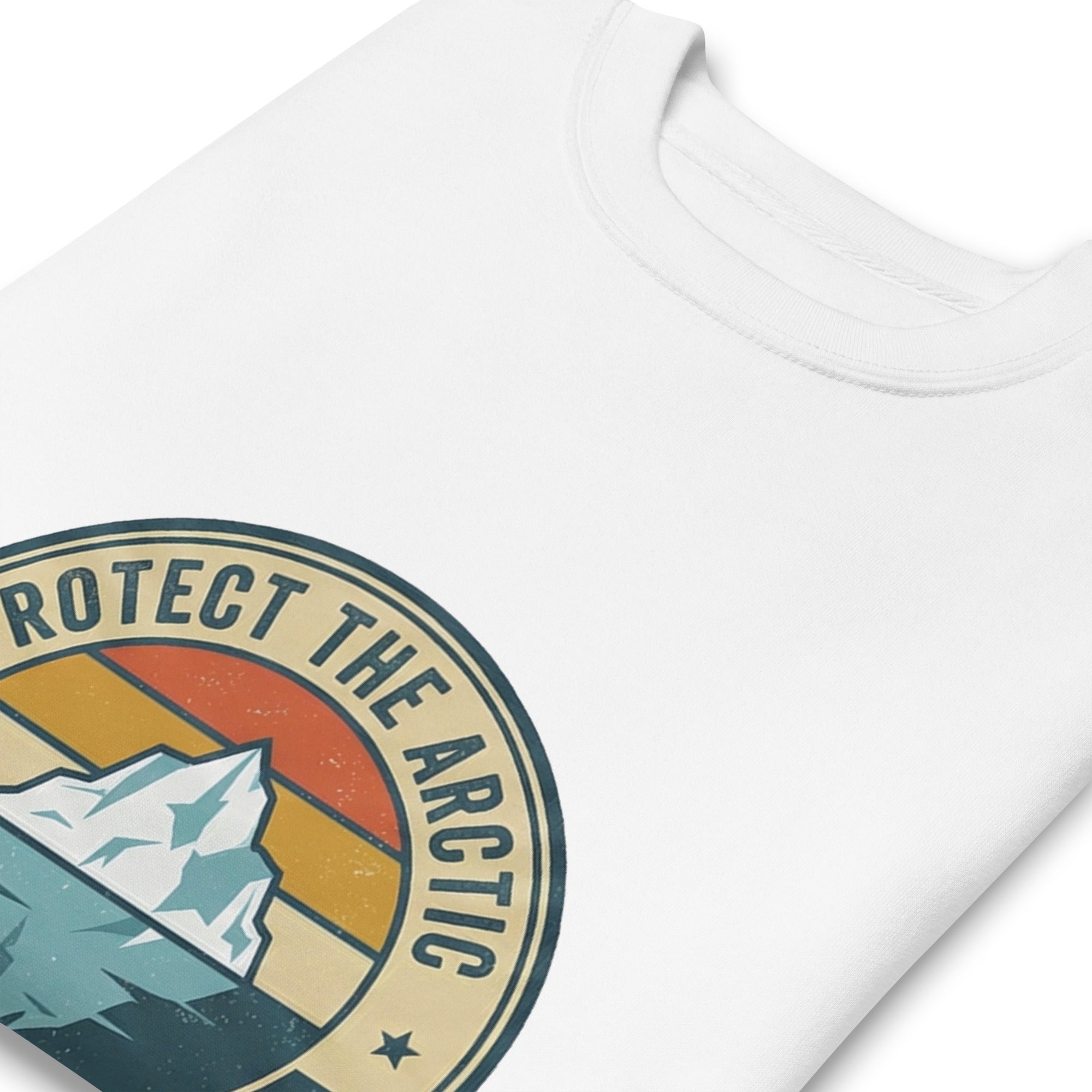 A close-up, high-angle shot of the neckline of a white sweatshirt, highlighting the ribbed collar and the colorful circular "Protect the Arctic" iceberg emblem printed on the chest.